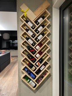 a wall mounted wine rack filled with bottles