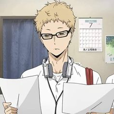 a man with headphones and glasses holding papers