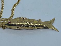 Vintage gilt  light weight new old stock articulaed fish pendant from the 70's on a 24 inch chain  total weight 5 grams  pendant 60cm long aprx. Luxury Gold Fish-shaped Necklace, Luxury Yellow Gold Fish-shaped Necklace, Articulated Fish Pendant, Fish Bracelet, Articulated Fish, St Christopher Pendant, Fishing Bracelet, Fish Pendant, Oval Locket