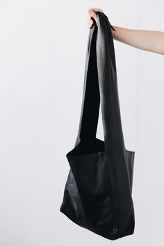 A soft form bag meant for the journey. It features a wide shoulder strap that can be tied in a variety of ways to suit the wearer. Daily Use Bags With Detachable Strap, Affordable Shoulder Bag With Detachable Strap, Lulus Black Handbag, A Perfect Circle, Dancing In The Rain, Straight Trousers, Small Wallet, Nice Leather, Fast Fashion