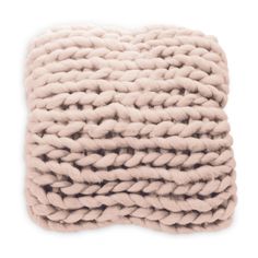 the chunky pillow in pink is made from thick yarn and has a square shape