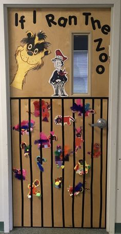 a door decorated with paper cut outs and stickers that say if i run the zoo