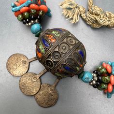 Gorgeous ~ Vintage Moroccan Berber enamel beaded necklace ~ featuring old berber enamel beads woven through a colorful beaded necklace ~ Back has thick thread with no clasp Dates early to mid 20th century . Materials : mix metal (looks like lower grade silver , except coin charms ) enamel faux coral and turquoise beads Measurements : Measures 26 inches in total length x 1 inches max width ~ Central pendant adds 2 inches x 3 inches in max drop length . Weighs 183 grams on my weighing scale . Cond Colorful Beaded Necklace, Moroccan Jewelry, Thick Thread, Silver Choker Necklace, Enamel Beads, Weighing Scale, Silver Enamel, Vintage Moroccan, Glass Necklace