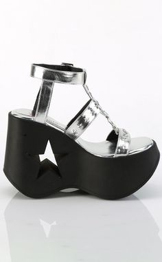 Be the star this summer in the DYNAMITE-12 sandals! These wedges are a strappy style sandal with a metal star cutout charm and matching star-shaped studs on the straps. The shoes secure with an adjustable ankle strap. Dress up n down for going out or casual summergoth looks! The DYNAMITE series features a 5 1/4 wedge with a statement star cutout in the heel. 100% Vegan. U.S women's sizing-refer to size chart for more info Thigh High Sock, Demonia Shoes, Studded Shoes, Black Platform Sandals, Metal Star, Pleaser Shoes, Stocking Tights, Metal Stars, Belt Purse