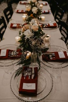 a long table is set with place settings for dinner guests to sit down and eat