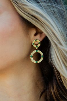 -18k gold-plated double circle earrings with gemstone details -Measures 1.75" -Available in Pearl, Green Onyx, Lapis and Tanzanite -Pair with Aspen necklace and Estes bracelet Elegant Jeweled Hoop Jewelry, Tarnish Resistant Green Round Jewelry, Gold Jeweled Hoop Jewelry, Green Tarnish Resistant Round Jewelry, Jeweled Metal Hoop Jewelry, Gold Jewelry For May Birthstone, Round Shape, Gold Hoop Jewelry For May Birthstone, Green Circular Metal Jewelry, Brass Jeweled Drop Earrings