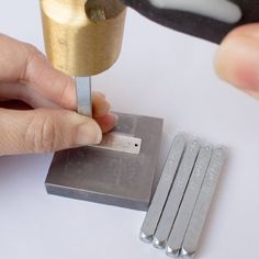 a person is using a small tool to cut out the metal parts for something else