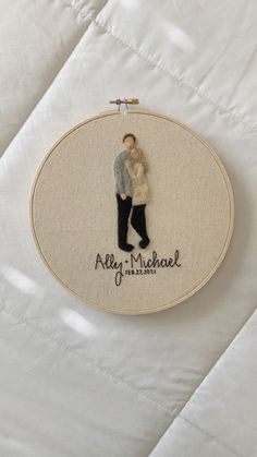 an embroidered picture of a man and woman on a white background with the words, ally michael