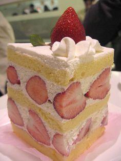 a piece of cake with strawberries on top