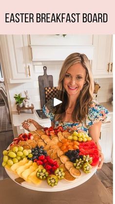 a woman holding up a platter full of fresh fruits and vegetables with the words, easter breakfast board