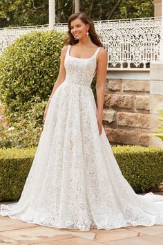 a woman in a wedding dress standing outside