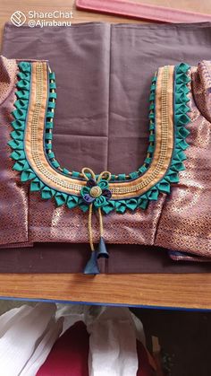 an elaborately decorated purse sitting on top of a wooden table