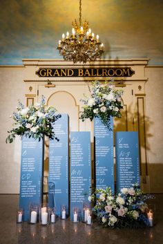 the grand ballroom is decorated with blue and white flowers, candles, and menus