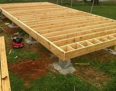 an unfinished bed frame sitting in the grass