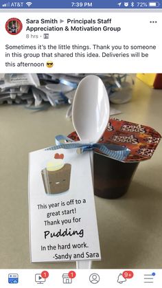 a cup with a spoon on top of it next to a sign that says appreciation & motivation group