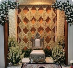 a chair sitting on top of a rug in front of a wall covered with flowers