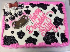 a decorated birthday cake with pink frosting and black icing on the bottom layer