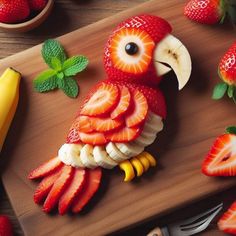 a wooden cutting board topped with sliced strawberries and an owl figurine