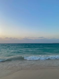 the ocean waves are rolling in to shore