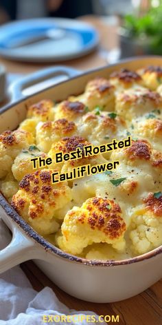 the best roasted cauliflower is in a white casserole dish on a wooden table