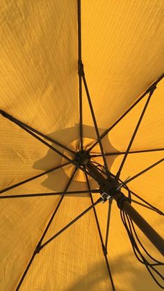 an open umbrella is shown with the sun shining on it's side and top