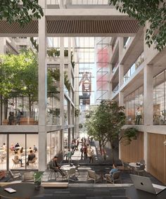 an office building with lots of windows and people sitting at tables in the lobby area