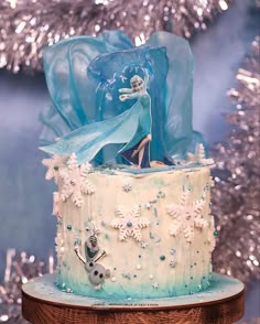 a frozen princess cake with frosting and decorations