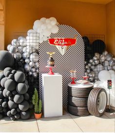 a room filled with lots of different types of decorations and balloons on the wall behind it