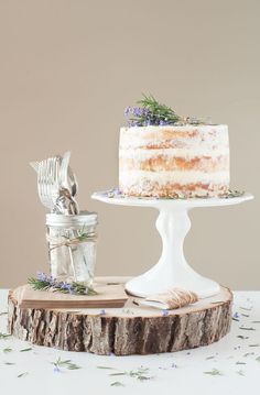 a white cake sitting on top of a wooden slice