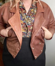 "Vintage 80s brown leather jacket. Brand tag has faded. Beautiful brown sugar color, snap button closures and has batwing cut and shoulder pads.  Great vintage condition! HAS SOME WEAR TO THE CUFFS AND A FEW SCATTERED MARKS BUT NOTHING CRAZY. See photos. No stains or holes.  Size: Not tagged. BEST FIT M-L. Always refer to measurements for more accurate sizing. Measurements taken laying flat/Double number where applicable: STS: 23\" PTP: 25\" across Waist: 17\" across SL: 16\" inseam, 9.5\" width L: 20\" ALL SALES ARE FINAL SO PLEASE DOUBLE CHECK THE MEASUREMENTS PRIOR TO BUYING AND DON'T HESITATE TO REACH OUT IF YOU HAVE ANY QUESTIONS!  All items are vintage/preloved and may have small imperfections. This should be expected for secondhand clothing. ALL MAJOR FLAWS WILL BE NOTED IN THE DESC Retro Brown Leather Jacket, Retro Brown Leather Jacket For Fall, Retro Brown Leather Jacket For Spring, Retro Vintage Brown Leather Jacket With Long Sleeves, Retro Long Sleeve Vintage Brown Leather Jacket, Retro Vintage Brown Leather Jacket, Retro Brown Leather Jacket With Buttons, Brown Leather Jacket With Buttons For Spring, Vintage Brown Leather Jacket With Buttons