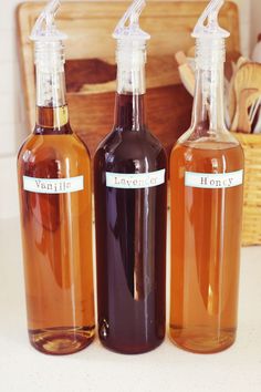 three bottles filled with liquid sitting on top of a counter