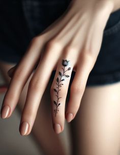 a woman's hand with a flower tattoo on it