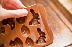 a person is placing chocolate in an ice cream mold