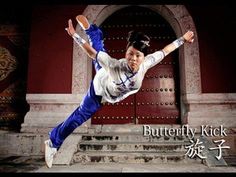 a man is doing an aerial trick in front of a red building with the words butterfly kick written on it