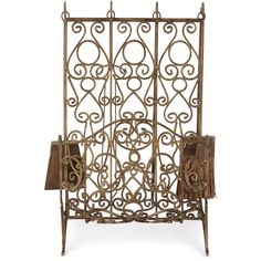 an ornate iron fireplace screen with tassels on the front and back sides,