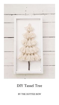 a small white christmas tree in a frame