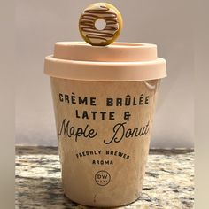 a coffee cup with a donut on top