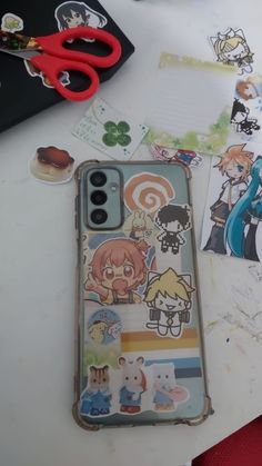 a cell phone case sitting on top of a table covered in stickers