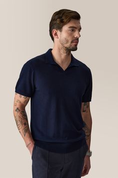 An updated classic. Open collar polo shirt in luxurious, fine gauge, light weight merino wool with rib trim. Luxury Business Polo Collar Tops, Luxury Business Tops With Polo Collar, Formal Fine Knit Cashmere Tops, Classic Polo Collar Tops For Business, Formal Merino Wool Fine Knit Top, Formal Fitted Polo Shirt With Ribbed Collar, Fitted Merino Wool Tops For Business Casual, Classic Cashmere Tops For Business Casual, Fitted Merino Wool Tops