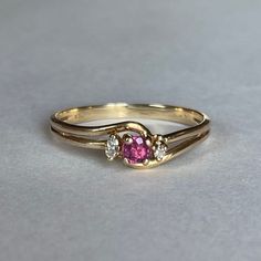 10K Gold Ruby and Natural Diamond Accent Ring, Size 7.75, 1.56 grams Beautiful Ring with Ruby center stone. One accent diamond stone is missing!  Size: 7.75 Weight: 1.56grams Main Stone: Ruby Color: Berry Pink Size: ca. 3mm dia. Secondary Stone: Natural Diamonds, 1.7mm dia. Marking: 10KP Gold: Yellow Gold Bandwidth: 2mm  Tested: Presidium Gemtester ll, Diamond Selector ll,  Olympus/Evident Scientific Vanta GX Precious Metals XRF Analyzer. Condition: Good preowned, 1 missing Diamond - Refer to pi Ring With Ruby, Unique Gold Jewelry Designs, Gold Bride Jewelry, Gold Rings Fashion, Gold Ring Designs, Bride Jewellery, Gold Jewellery Design, Ring Size 7, Diamond Stone