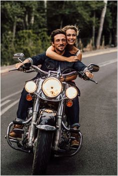 a man and woman riding on the back of a motorcycle