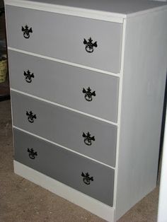 a white and gray dresser with black handles