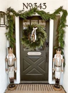 the front door is decorated with wreaths and nutcrackers