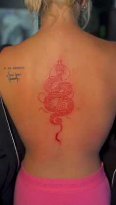 a woman with a tattoo on her back