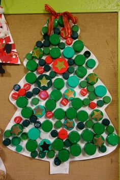 a christmas tree made out of buttons on a bulletin board