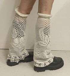 the legs and ankles of a woman wearing white crochet socks