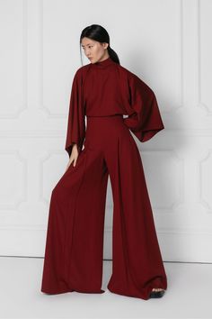 IO Jumpsuit features an exaggerated wide leg, pleat front detail and a high waist perfectly balanced out with traditionally tailored Kimono style sleeves and a high neck with 3 button closures at the back of the neck and an elegant open back. Suit Jumpsuit, Dramatic Style, Designer Jumpsuits, Custom Made Clothing, Pantsuits For Women