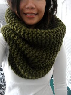 a woman wearing a green knitted cowl