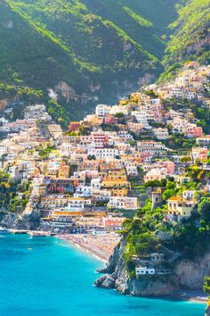 the beach is lined with houses and cliffs