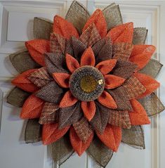 an orange and brown burlocked sunflower on a door